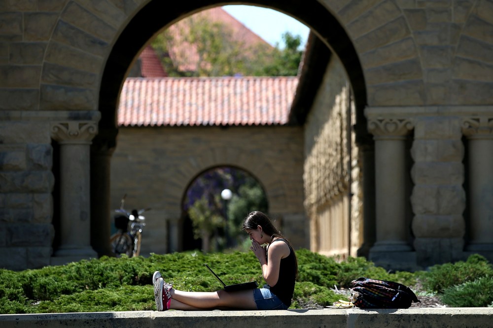A woman works on a laptop on the Stanford University campus on May 22, 2014 in Stanford, California.