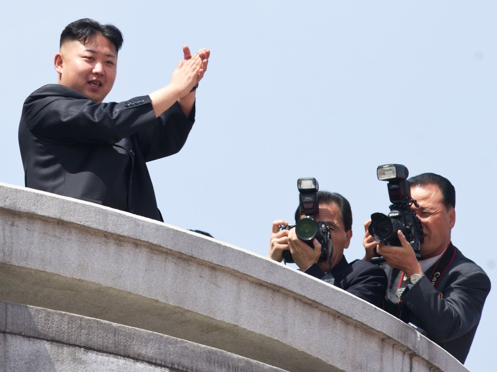 File photo: North Korean leader Kim Jong-Un (L) applauds during a military parade in honour of the 100th birthday of the late North Korean leader Kim Il-Sung in Pyongyang on April 15, 2012. (Photo by Ed Jones/AFP/Getty Images file)