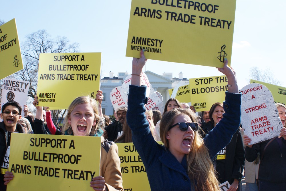 Amnesty International protestors demonstrate outside of the White House in Washington, DC, on March 22, 2013. The protestors were urging President Obama to support a bulletproof Arms Trade Treaty. Photo by Nicole Sakin/AFP/Getty Images)