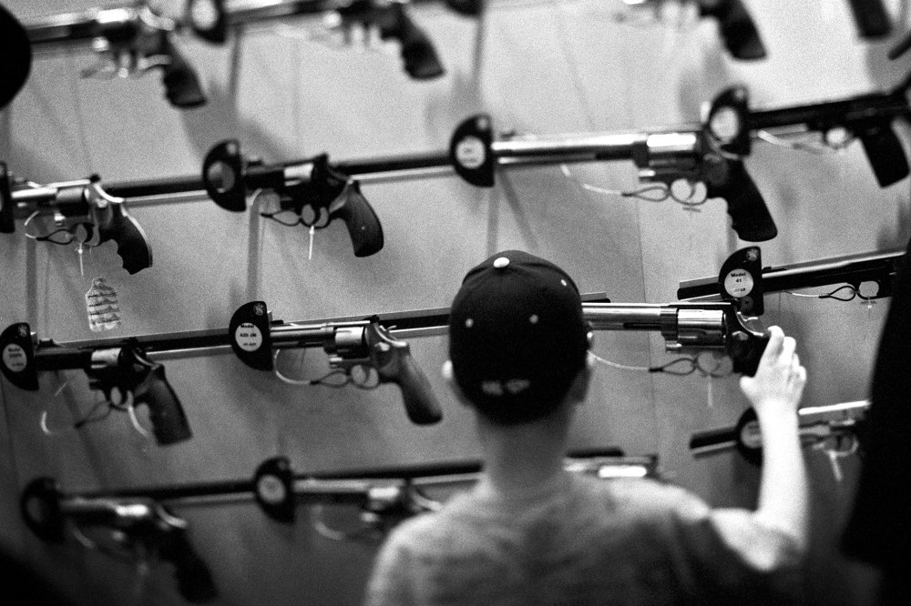 An attendee looks at a display of guns during one of the National Rifle Association's (NRA) Annual Meetings.