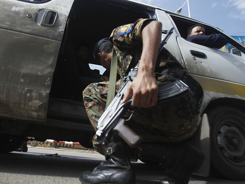 A police trooper checks a van at the entrance of Sanaa International Airport August 7, 2013.  (Photo by Khaled Abdullah/Reuters)