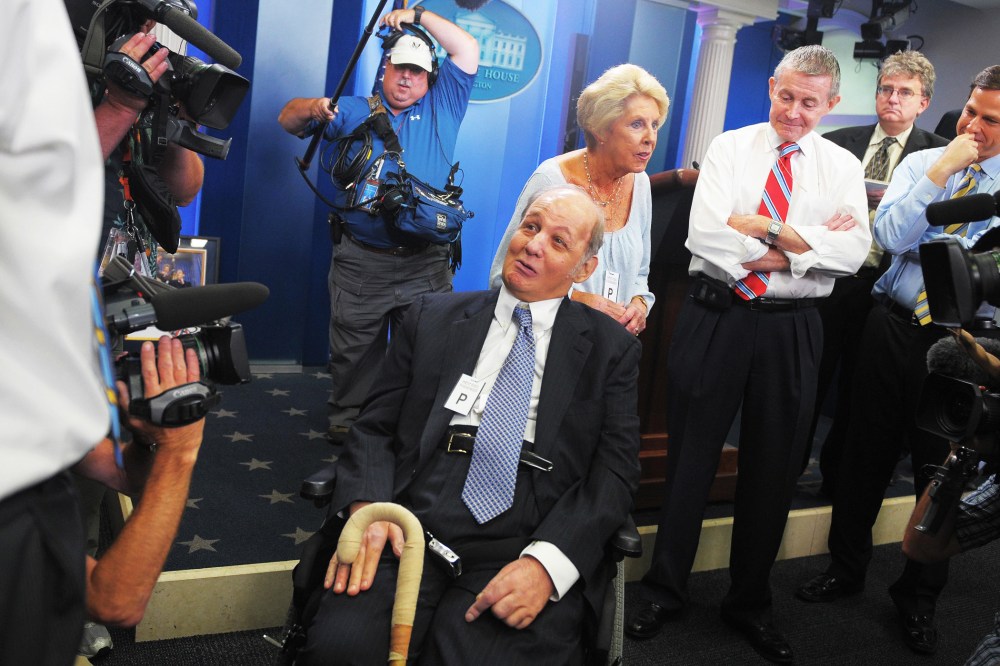 James Brady (C), former White House press secretary for president Ronald Reagan, and his wife Sarah (3rd L) chat with journalists, June 16, 2009.