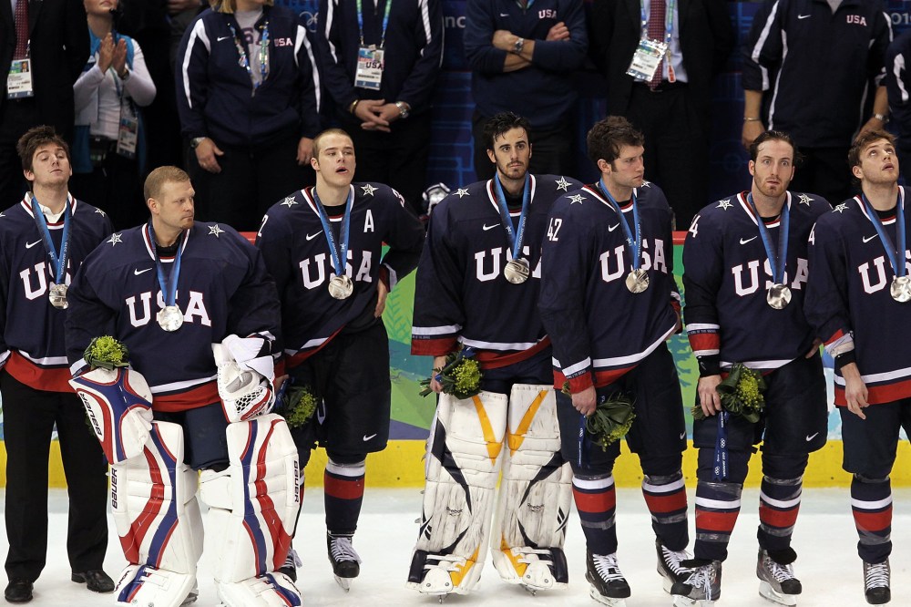 Members of the USA hockey team look on dejectedly after receiving their silver medals following their 3-2 overtime loss to Canada, Feb. 28, 2010.