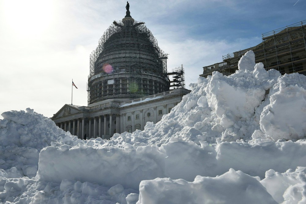 The U.S. Capitol rises above a large mound of snow cleared from the East Front on Jan. 25, 2016 in Washington, D.C. (Photo by Mandel Ngan/AFP/Getty)