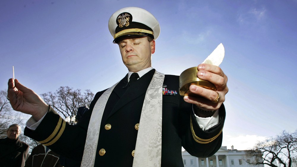 Navy Chaplain Lt. Gordon J. Klingenschmitt is pictured as he conducts a worship service in front of the White House, background, Saturday, Jan. 7, 2006, in Washington, D.C. (Photo by Manuel Balce Ceneta/AP)