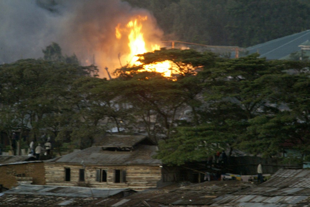 Flames are seen in the Kibera slums, Sunday, Dec. 30, 2007, after violence broke out after President Mwai Kibaki was declared the winner of presidential elections.  Elections chief Samuel Kivuitu, who read the result on live television after other...