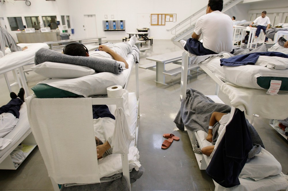 Detainees rest on bunks inside the "B" cell and bunk unit of the Northwest Detention Center in Tacoma, Wash.