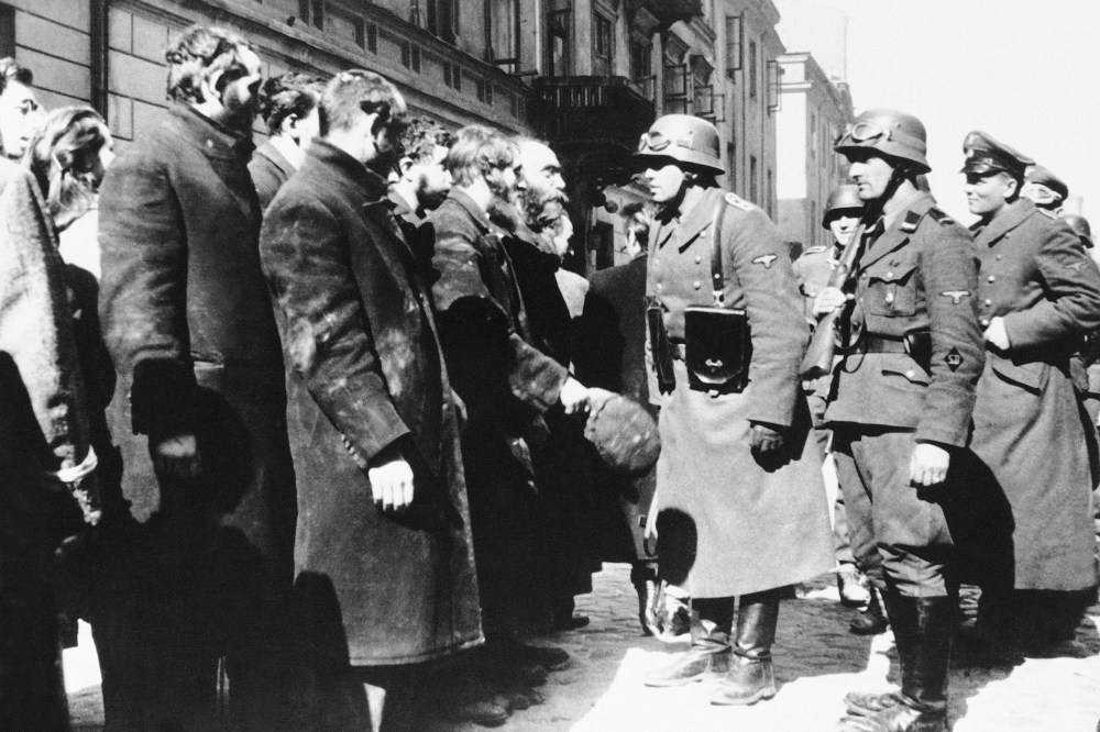 Nazi officers talk with citizens of the Warsaw ghetto, Poland, spring 1943. (Photo by AP)