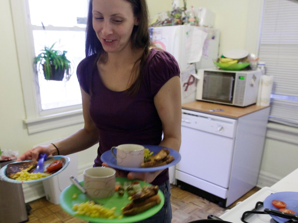 File Photo: Lisa Zilligen, 28, serves lunch for her three children at her home in Chicago, Nov. 23, 2009. Zilligen, a single mother and full time student at Loyola University has been getting food stamps for the past several months; sometimes the...