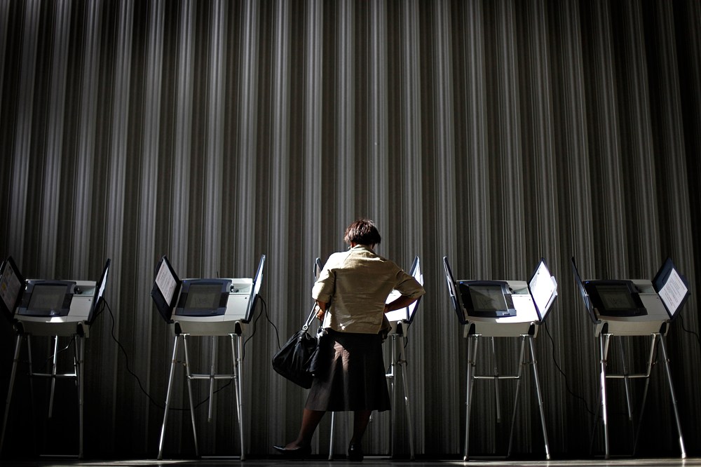 A woman casts her ballot during early voting, Oct., 26, 2010, in Atlanta, Ga.