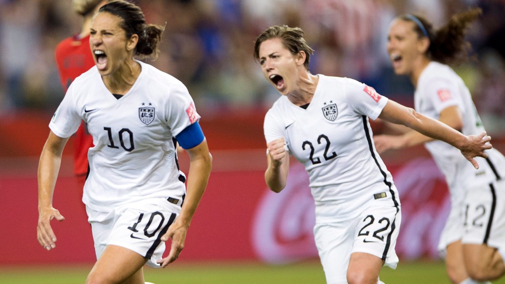 US team's Carli Lloyd (10) after scoring a penalty kick against Germany as Meghan Klingenberg (22) follows during a semifinal in the Women's World Cup soccer tournament, June 30, 2015, in Montreal, Canada. (Photo by Ryan Remiorz/The Canadian Press/AP)