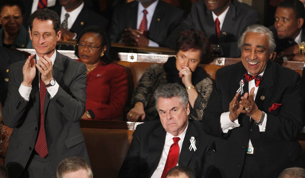 Rep. Anthony Weiner, D-N.Y., left, and Rep. Charles Rangel, D-N.Y., right stand and applaud as Rep. Peter King, R-N.Y. sits during President Barack Obama's State of the Union address in Washington, Tuesday, Jan. 25, 2011.