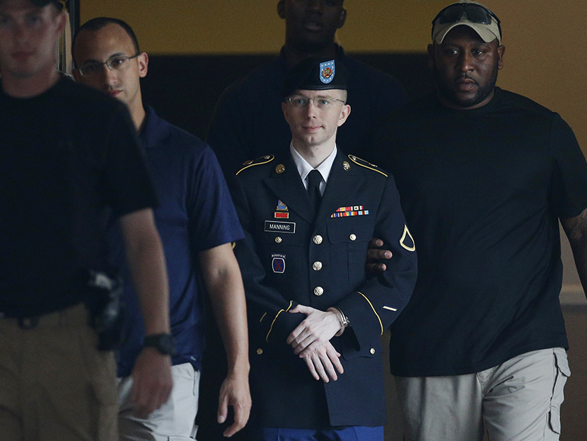 Army Pfc. Bradley Manning, second from right, is escorted to a waiting security vehicle outside of a courthouse in Fort Meade, Md., Monday, July 15, 2013, after appearing for a hearing at his court martial. (Photo by Patrick Semansky/AP)