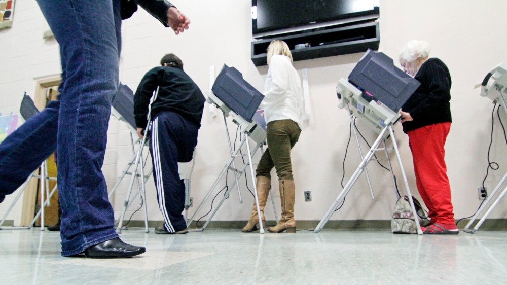 A voter walks to an empty electronic voting booth at a Madison, Miss., precinct, Tuesday, Nov. 6, 2012.