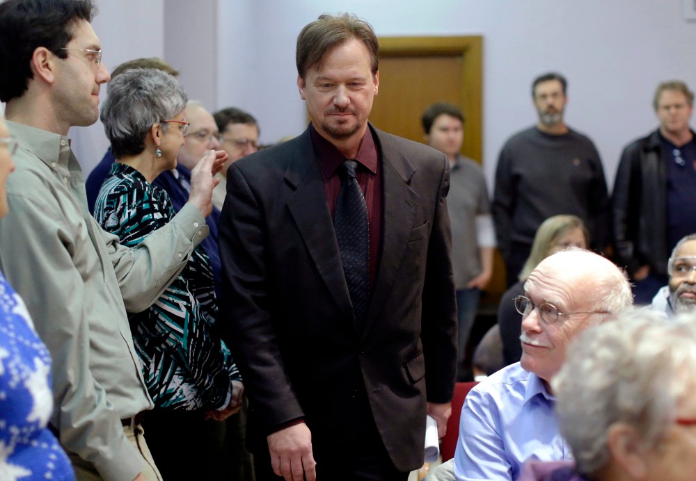 A man places a hand on the shoulder of The Rev. Frank Schaefer, a United Methodist clergyman convicted of breaking church law for officiating at his son's same-sex wedding, as he enters a news conference, Dec. 16, 2013, at the Arch Street United Methodist