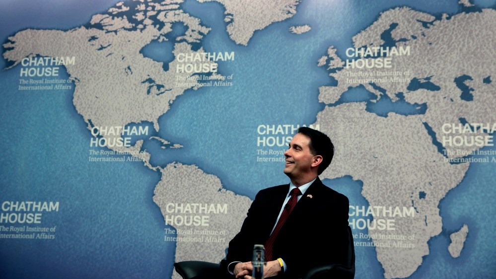 Wisconsin Gov. Scott Walker laughs as he is introduced prior to his speech at Chatham House in central London, Feb. 11, 2015. (Photo by Lefteris Pitarakis/AP)