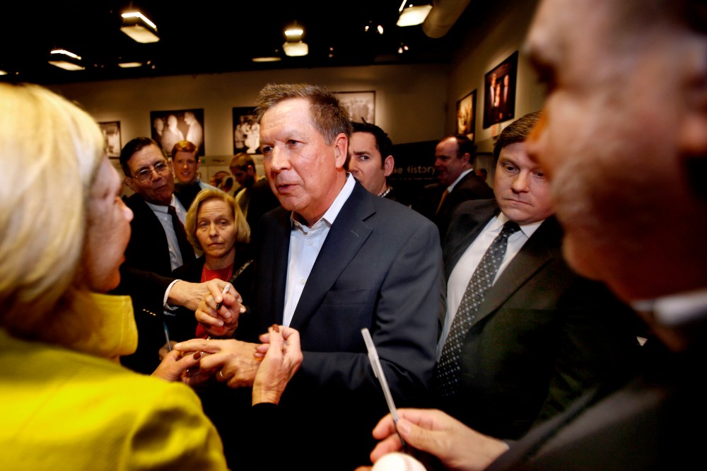 Ohio Gov. John Kasich, R-Ohio is greeted after speaking at a breakfast with state political activist and area business leaders hosted by the New Hampshire Institute of Politics at Saint Anselm College, March 24, 2015. (Photo by Jim Cole/AP)