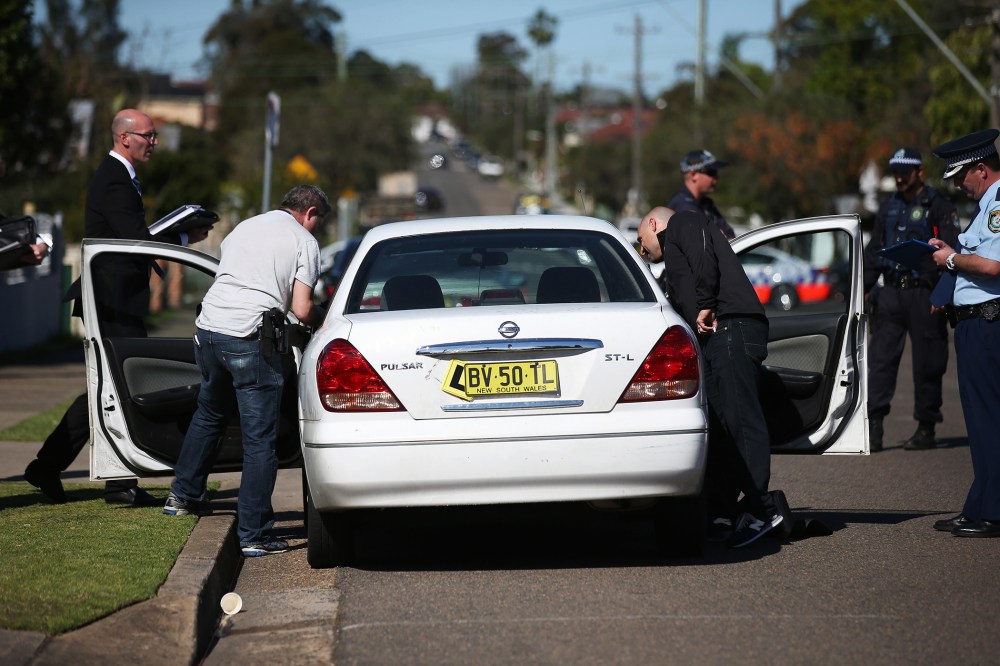 Police investigators search a car at a home at Guildford in suburban Sydney, Sept. 18, 2014.