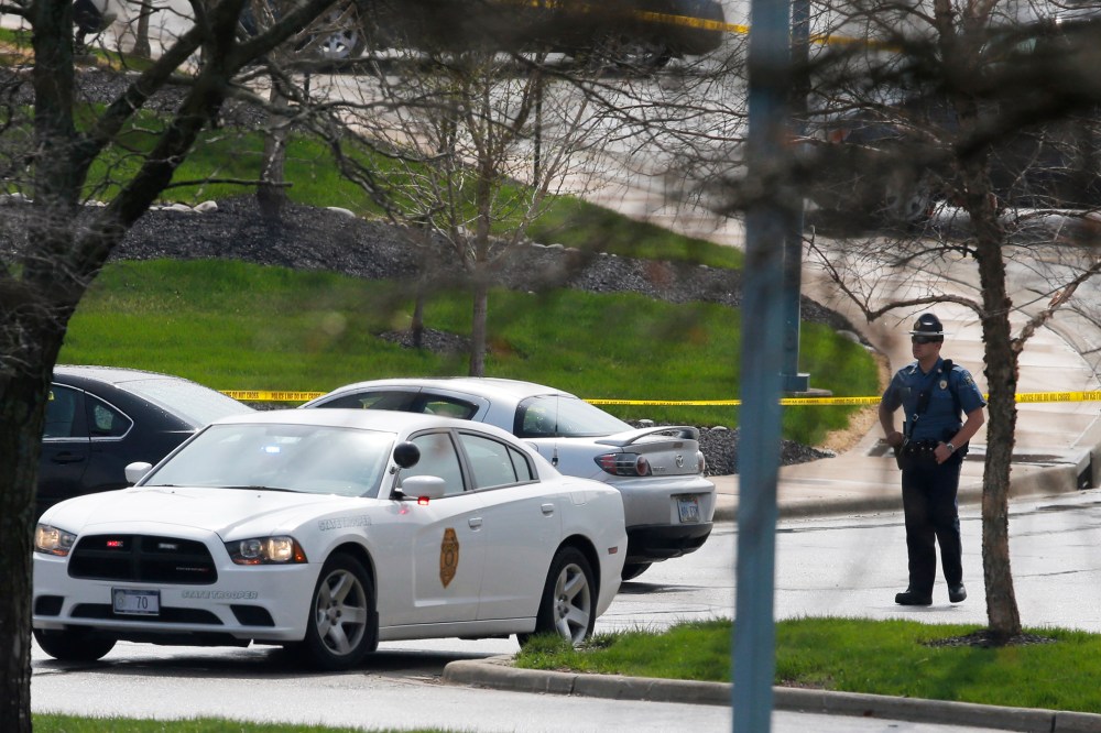 A Kansas State Trooper stands near the location of a shooting at the Jewish Community Center in Overland Park, Kan., April 13, 2014.