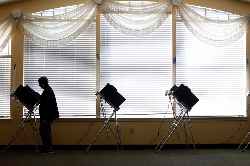 A voter casts her electronic ballot, Nov. 4, 2014 at her precinct in Madison, Miss. (Photo by Rogelio V. Solis/AP)