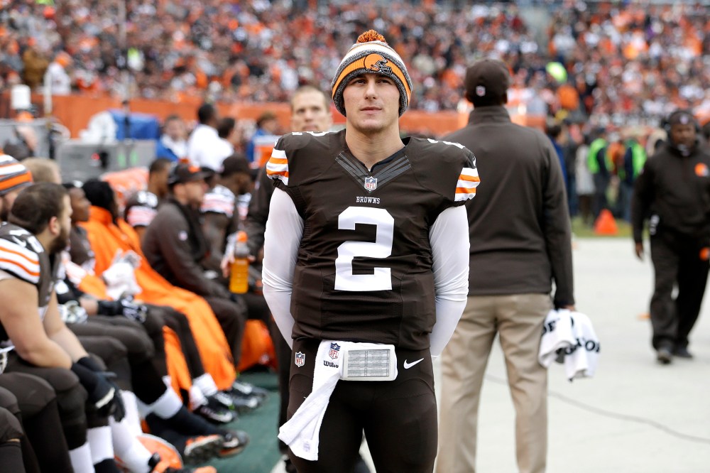 Cleveland Browns quarterback Johnny Manziel (2) watches from the sidelines in the first quarter of an NFL football game against the Cincinnati Bengals, Dec. 14, 2014, in Cleveland, Ohio. (Photo by Tony Dejak/AP)