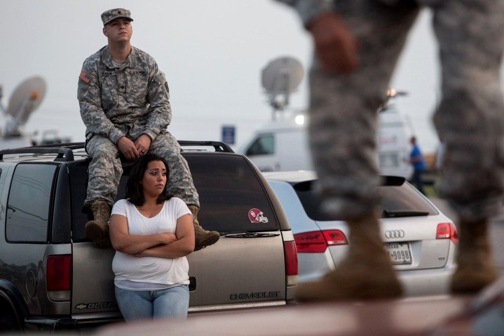 Lucy Hamlin and her husband, Spc. Timothy Hamlin, wait for permission to re-enter the Fort Hood military base, where they live, following a shooting on base on April 2, 2014, in Fort Hood, Texas.