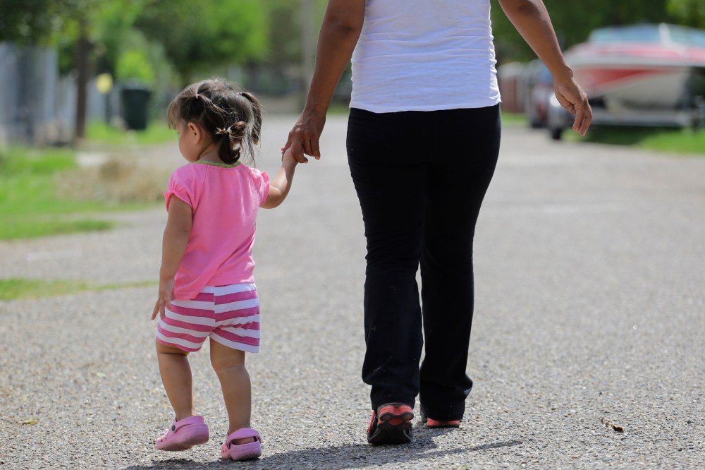 A woman who is in the country illegally walks with her two-year-old daughter who was born in the in the United States but was denied a birth certificate, Sullivan City, Texas, Sep. 16, 2015. (Photo by Eric Gay/AP)