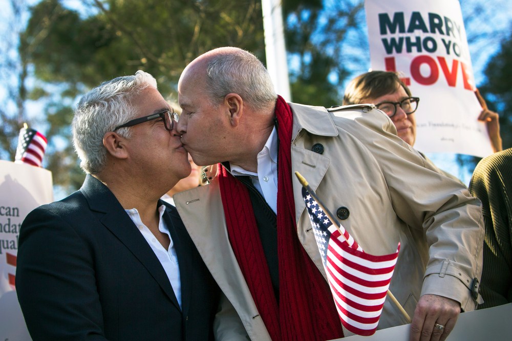 Robert Roman and Claus Ihlemann, of Virginia Beach, celebrate Thursday's ruling that Virginia's same-sex marriage ban was unconstitutional, Feb. 14, 2014, in Norfolk, Va.