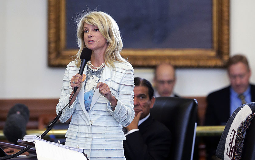 Standing in front of a portrait of President Lyndon B. Johnson, Sen. Wendy Davis, D-Fort Worth, begins a filibuster in an effort to kill an abortion bill, Tuesday, June 25, 2013, in Austin, Texas. The bill would ban abortion after 20 weeks of pregnancy...