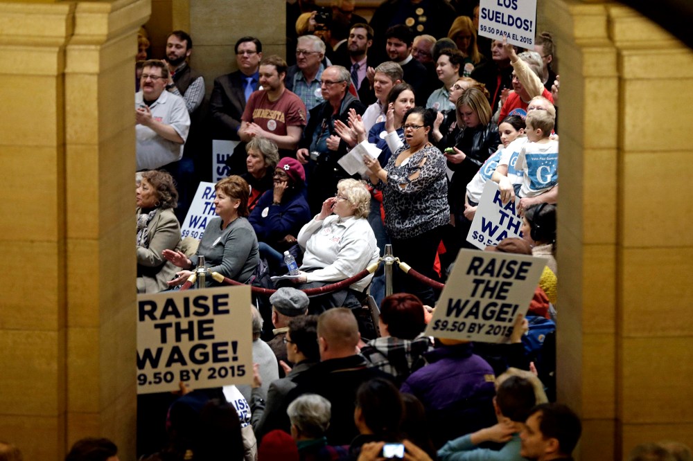 Demonstrators rally at the Minnesota State Capitol in favor of raising the minimum wage on Feb. 25, 2014, in St. Paul, Minn.