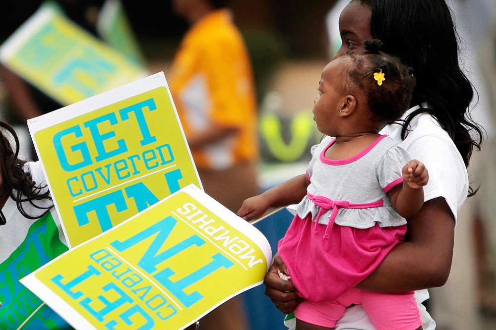Volunteers from the Memphis Ambassadors Program lend their support to an Affordable Care Act rally at the Central Library in Memphis, Tenn. Monday, Sept. 30, 2013.