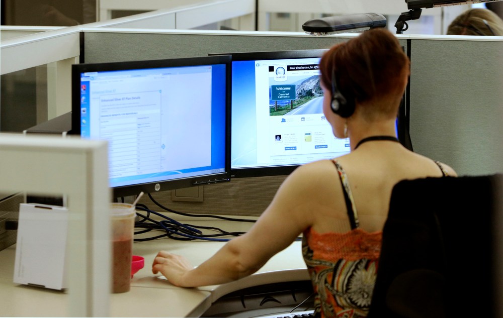 Gina Macaluso, an employee of Covered California, the state's new health care exchange, provides health insurance at the newly opened call center in Rancho Cordova, Calif., Tuesday, Oct. 1, 2013.