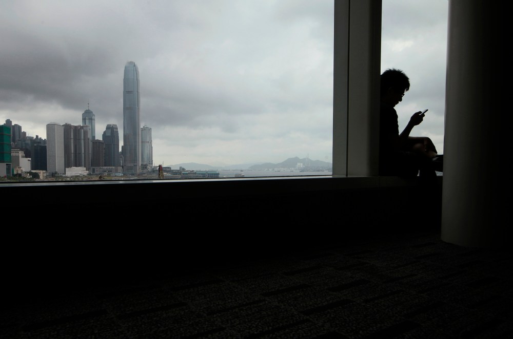 A man uses his smartphone in Hong Kong, June 16, 2013.