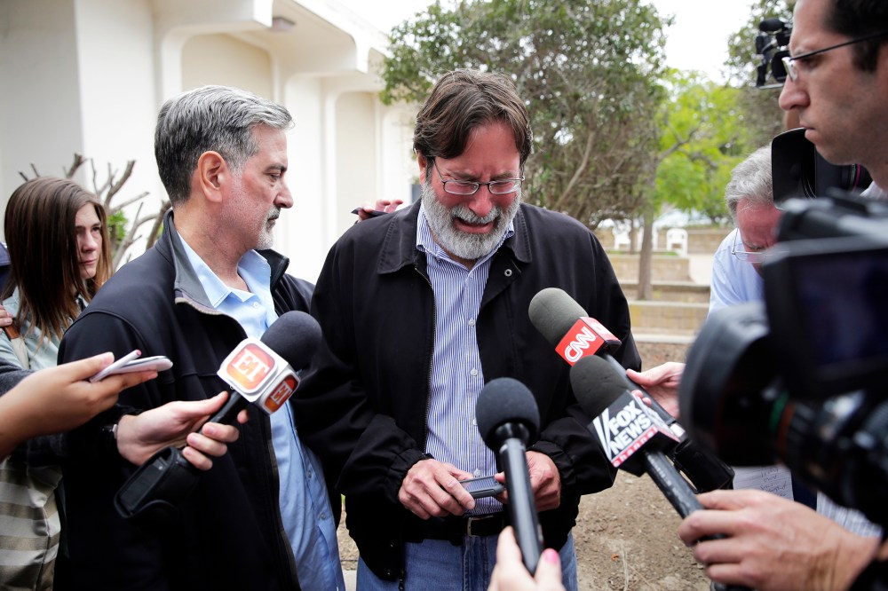 Richard Martinez is comforted by his brother, Alan, as he talks to media outside the Santa Barbara County Sheriff's Headquarters, May 24, 2014.