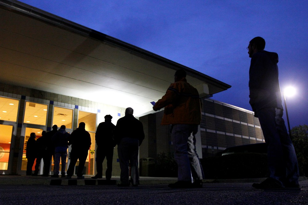 Voters stand in line before the sun rises to cast their votes at a polling precinct at the Wake County Firearms Education and Training Center in Apex, N.C., on Election Day, Nov. 6, 2012.