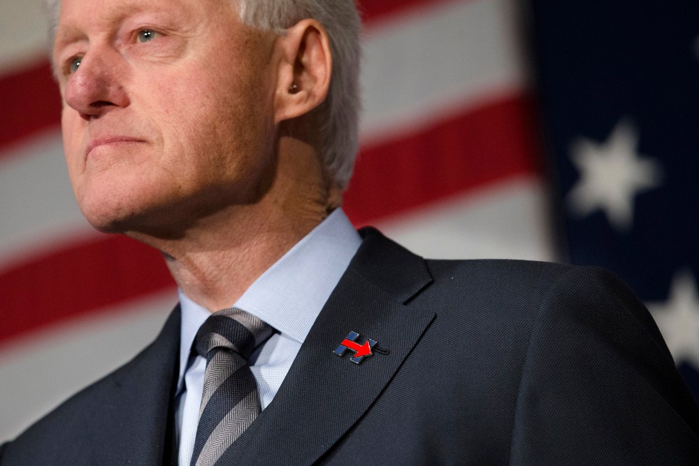 Former President Bill Clinton wears a campaign pin for his wife, Democratic presidential candidate Hillary Clinton, as he campaign for her, Feb. 12, 2016, at the Clifton Cultural Arts Center in Cincinnati. (Photo by John Minchillo/AP)