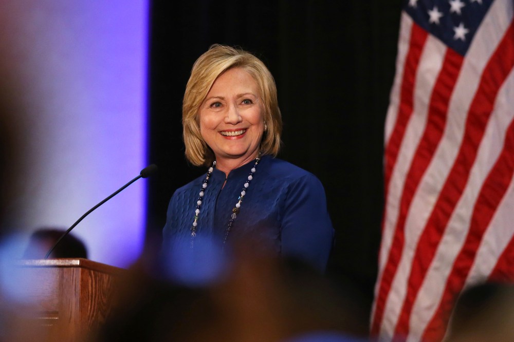 Former Secretary of State Hillary Rodham Clinton acknowledges applause during a speech at an event in the east Denver suburb of Aurora, Colo., on Oct. 21, 2014. (Photo by David Zalubowski/AP)