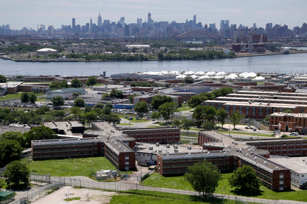 This June 20, 2014 file photo shows the Rikers Island jail with the New York skyline in the background. (Photo by Seth Wenig/AP)
