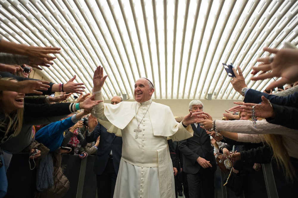 Pope Francis is cheered by faithful upon his arrival for the weekly general audience in the Pope Paul VI hall, at the Vatican, Feb. 4, 2015. (Photo by L'Osservatore Romano/Pool/AP)