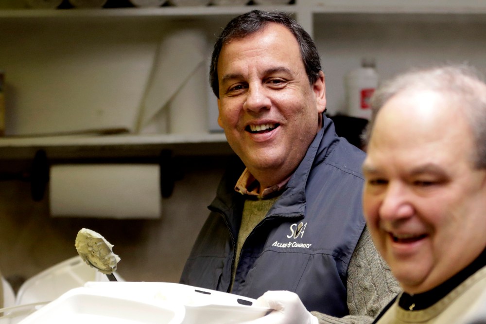 New Jersey Gov. Chris Christie, left, and Newark Archbishop Bernard Hebda converse while preparing plates to hand out during a pre-Thanksgiving meal at the St. John's Church soup kitchen on Nov. 26, 2014, in Newark, N.J.