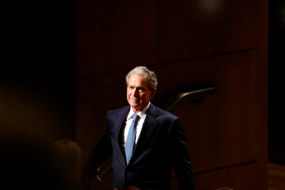 Former President George W. Bush smiles as he walks off stage during an event on Feb. 19, 2014, in Dallas, Texas. (Photo by LM Otero/AP)