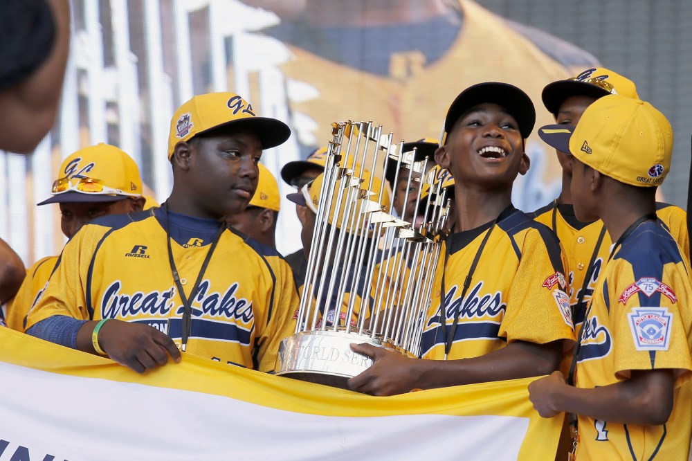 In this Aug. 27, 2014, file photo, members of the Jackie Robinson West Little League baseball team participate in a rally in Chicago celebrating the team's U.S. Little League Championship. (Photo by Charles Rex Arbogast/AP)