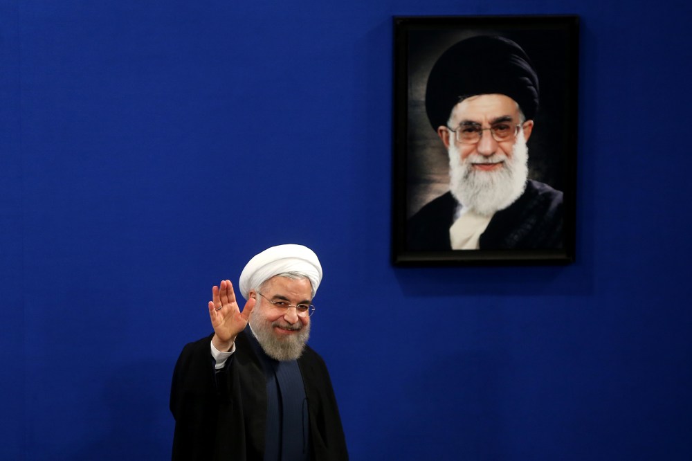 Iran's President Hassan Rouhani waves to reporters at the conclusion of his press conference in Tehran, Iran, Aug. 29, 2015. (Photo by Ebrahim Noroozi/AP)