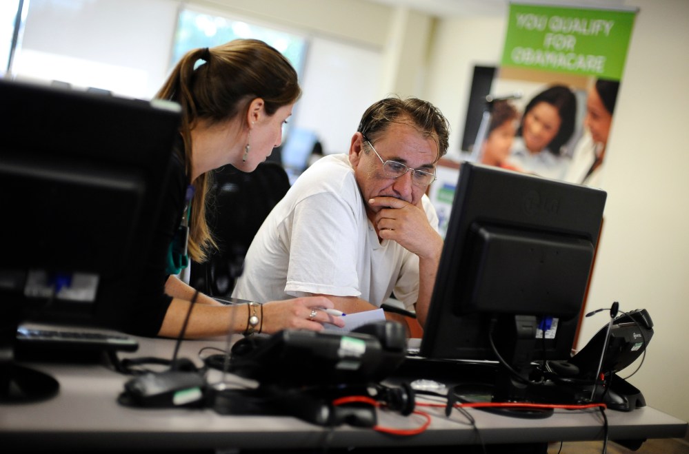 Outreach and eligibility associate Shannon Bali helps Boguslaw Dudek enroll in the nation's new health insurance system at the Community Health Center, in New Britain, Conn., Oct. 1, 2013.