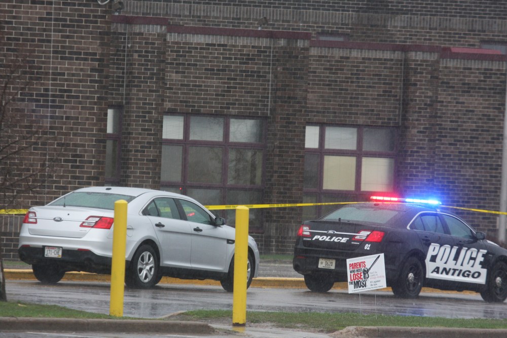 Two Antigo police department vehicles sit in front of the entrance to Antigo High School, April 24, 2016, where an 18-year-old gunman opened fire late Saturday outside of a prom at the school. (Photo by Fred Berner/Antigo Daily Journal/AP)
