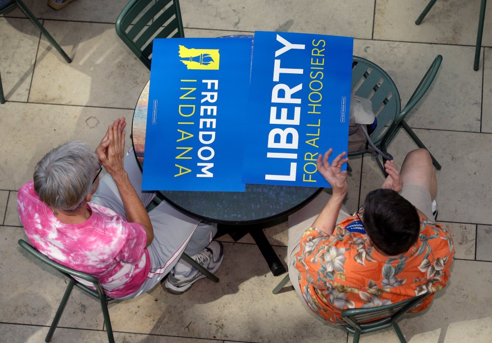 Same-sex marriage supporters listen during the announcement of the new group, called Freedom Indiana, in Indianapolis, Aug. 21, 2013.
