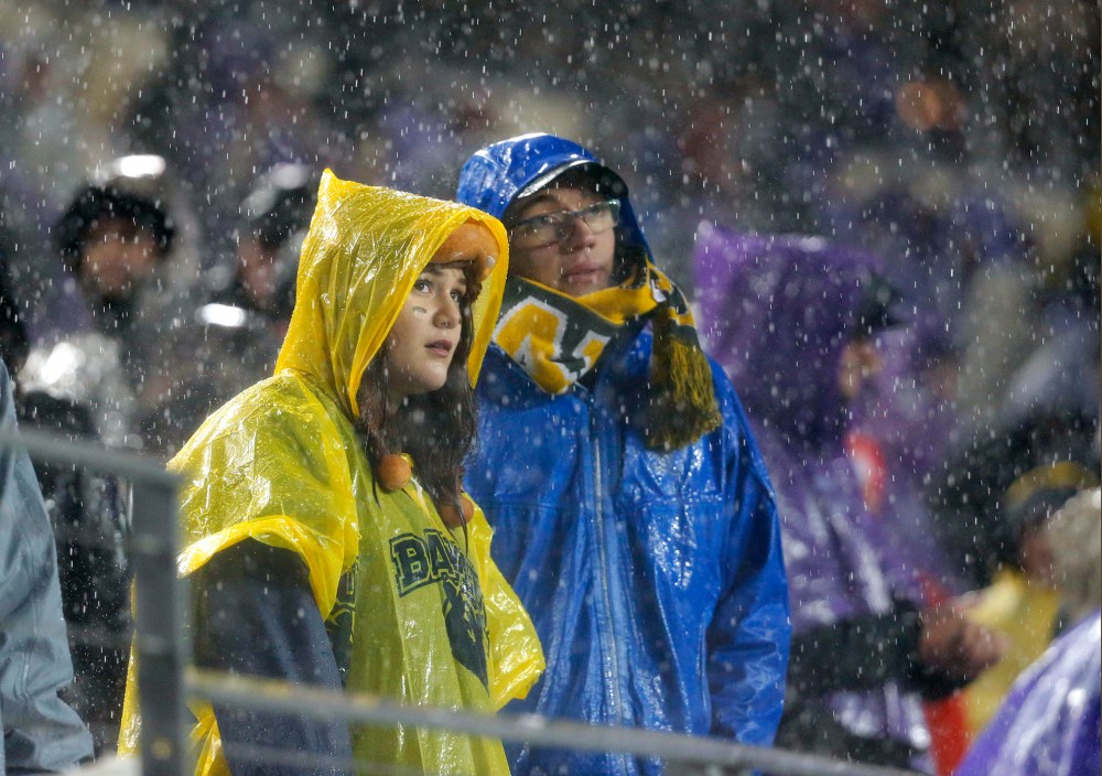 Baylor fans watch the game against TCU in the second half of an NCAA college football game as rain pours down over the stadium, Nov. 27, 2015, Fort Worth, Texas. (Photo by Tony Gutierrez/AP)