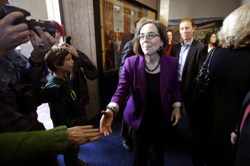 Oregon Secretary of State Kate Brown greets people during a celebration at the Oregon Historical Society to mark the 156th anniversary of Oregon's admission to the union as the 33rd state in Portland, Ore., Feb. 14, 2015. (Photo by Don Ryan/AP)