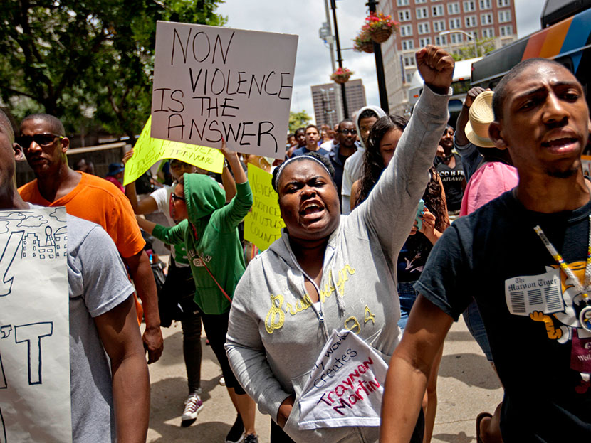 Lisa Archer, 24, of Atlanta, center, chants as protestors march, Sunday, July 14, 2013, in Atlanta the day after George Zimmerman was found not guilty in the 2012 shooting death of teenager Trayvon Martin. (Photo by David Goldman/AP)