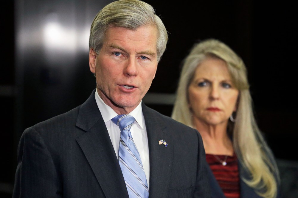 Former Virginia Gov. Bob McDonnell makes a statement as his wife, Maureen, listens during a news conference in Richmond, Va., Jan. 21, 2014.